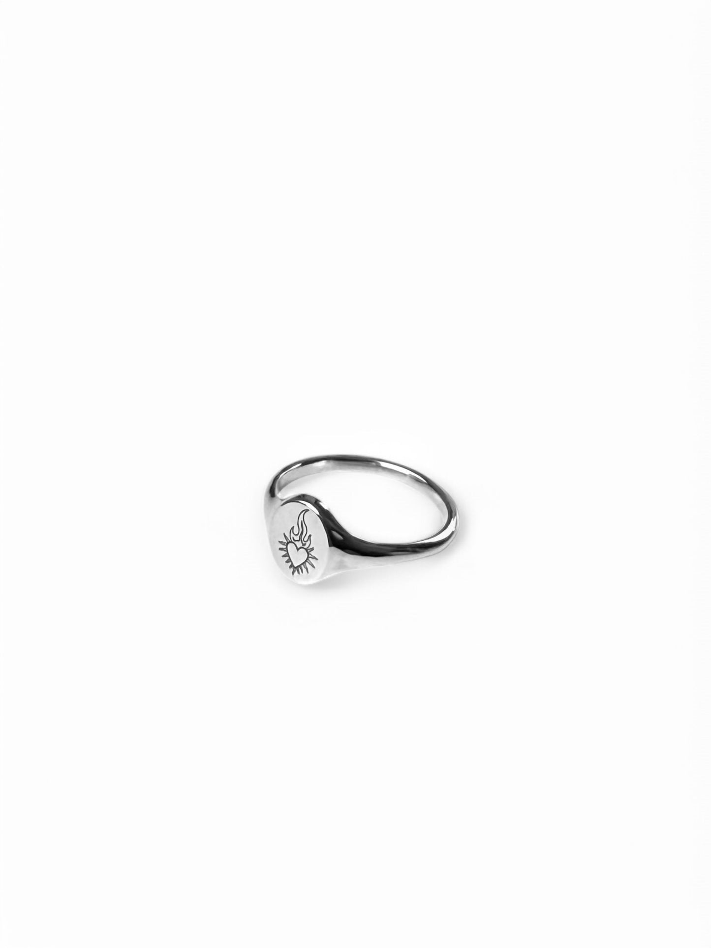 Silver mini signet ring with flaming heart enraved on it. Sold on its own( shop other rings on the website)