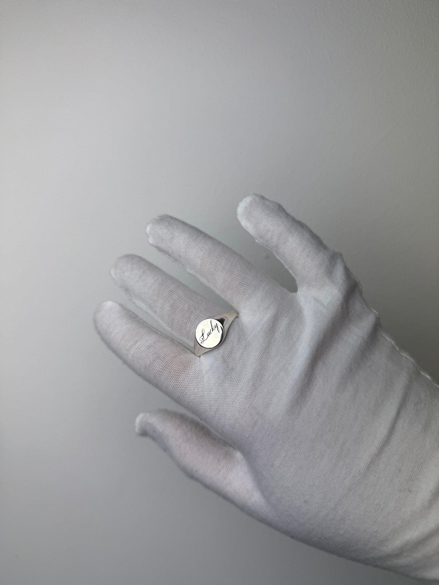 Round silver signet ring with ‘lucky’ engraved on it. Comes on its own. Other rings available on the website