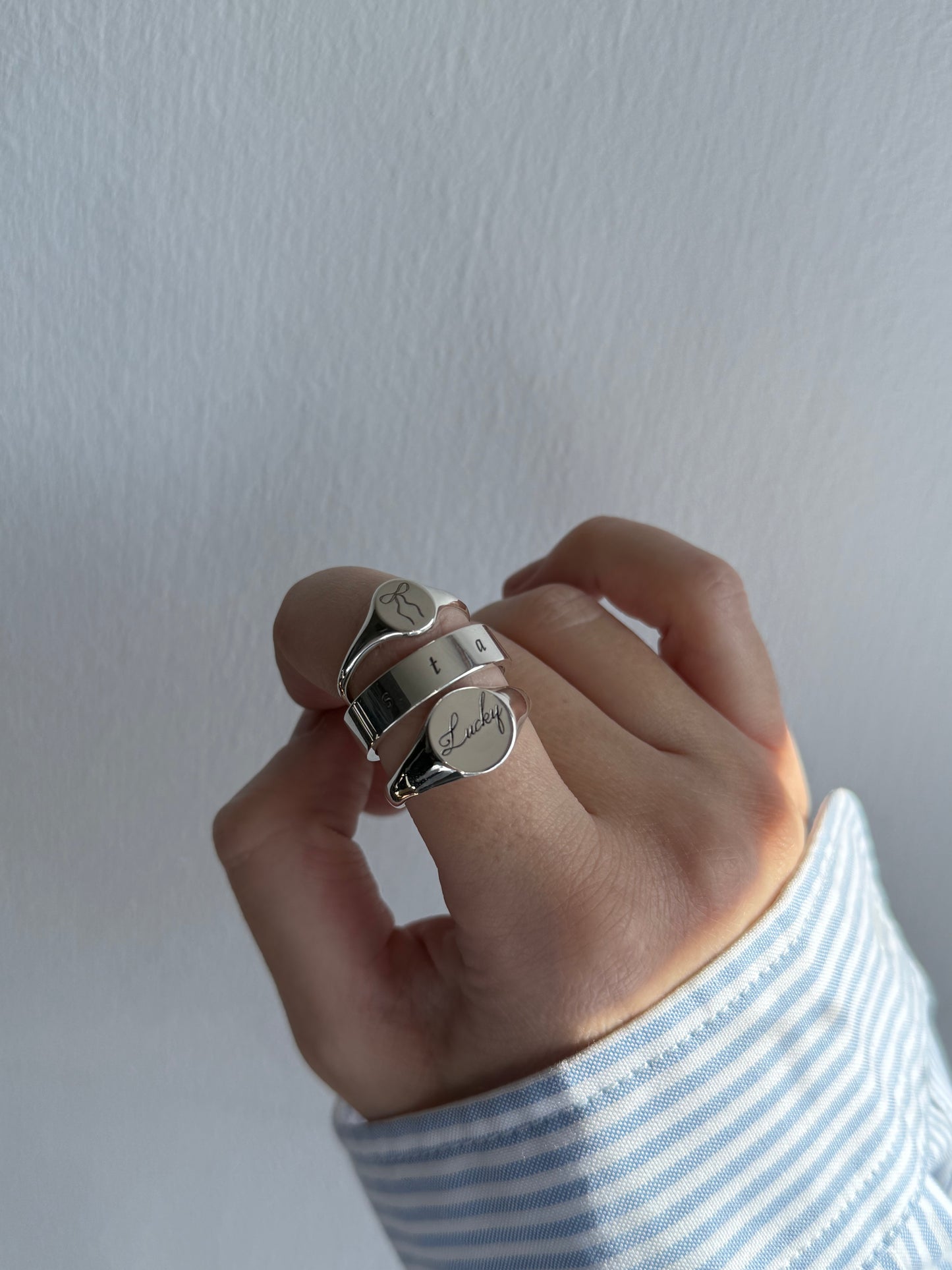 Round silver signet ring with ‘lucky’ engraved on it. Comes on its own. Other rings available on the website