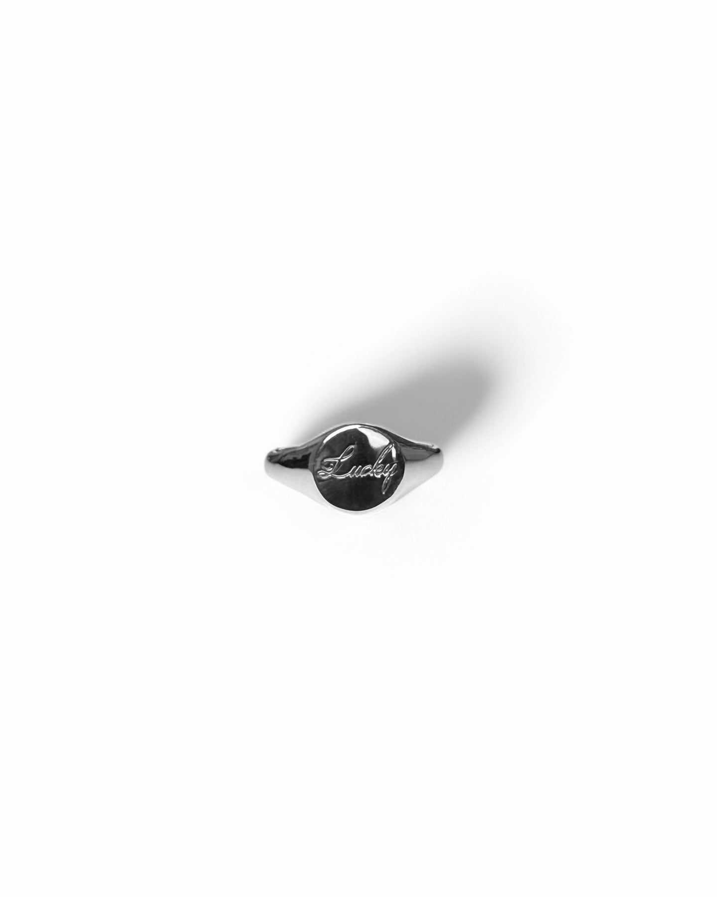 Round silver signet ring with ‘lucky’ engraved on it. Comes on its own. Other rings available on the website