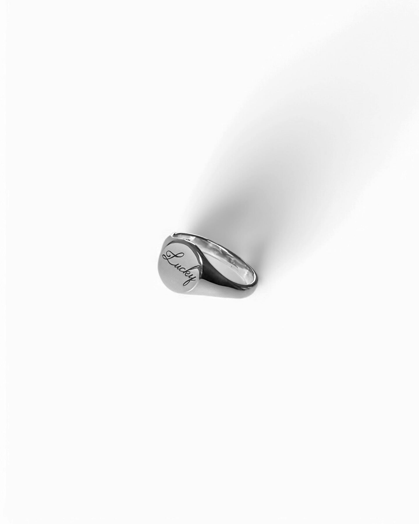 Round silver signet ring with ‘lucky’ engraved on it. Comes on its own. Other rings available on the website